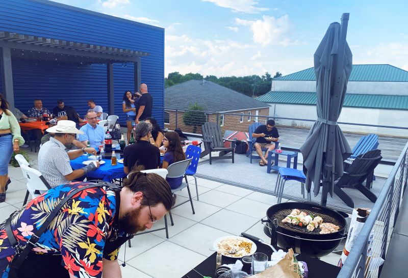 Employees of Dressler Automation gather on a rooftop to eat and relax.